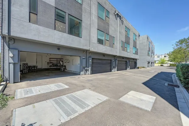 a view of a building with a garden and pathway