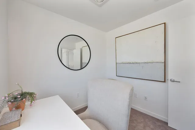 a kitchen with stainless steel appliances a table and chairs in it