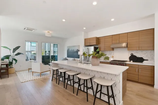 a view of a dining room with furniture and a chandelier