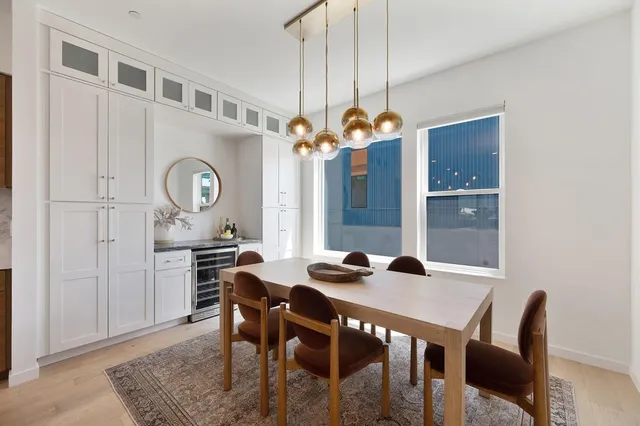 a view of a dining room with furniture and chandelier