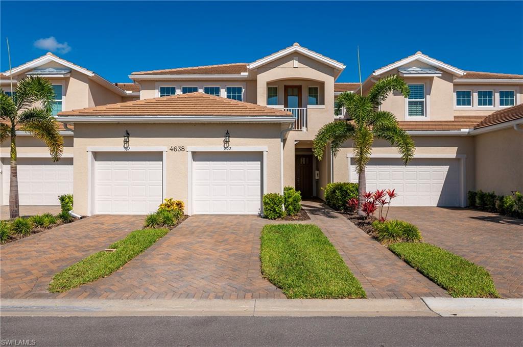 a front view of a house with a yard and a garage