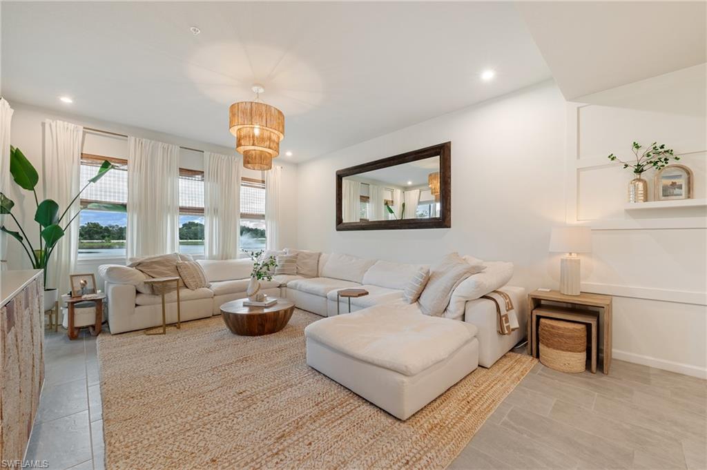 4638 Arboretum Circle, Unit 102 Naples, FL 34112 - Photo 2 of 20 a living room with furniture a large window and a potted plant