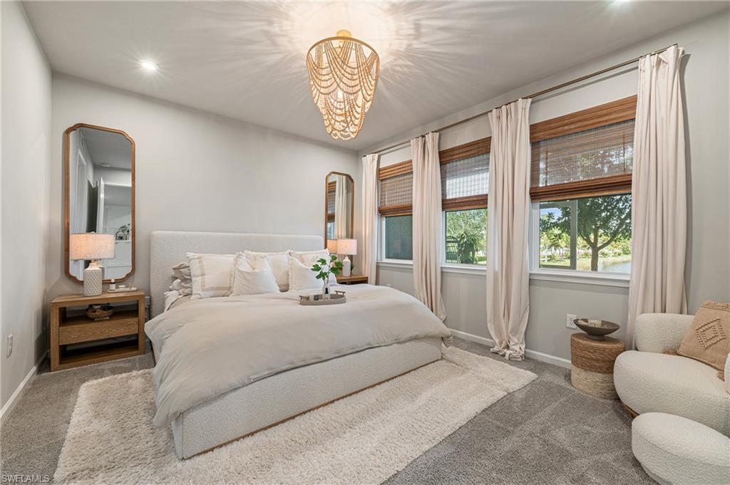 4638 Arboretum Circle, Unit 102 Naples, FL 34112 - Photo 4 of 20 a bedroom with a large bed and a large window
