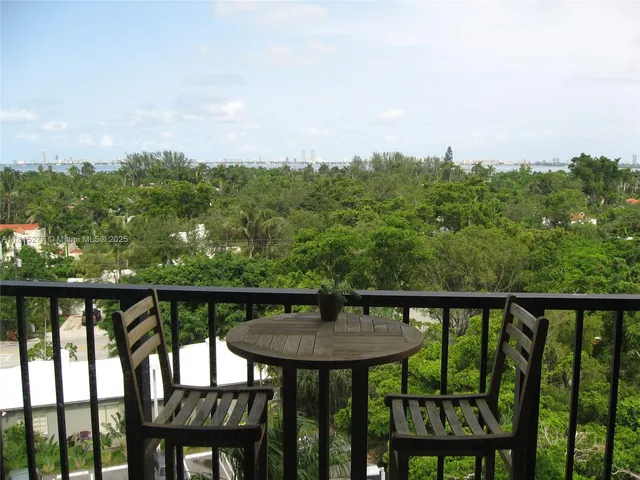 a view of a balcony with furniture and wooden floor