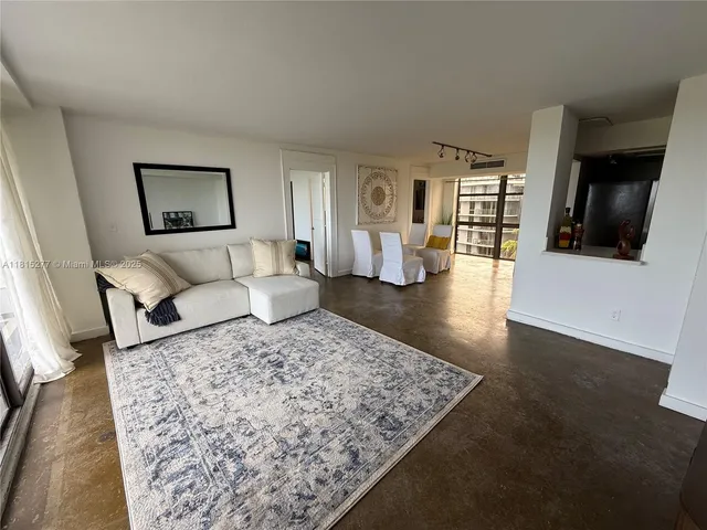 a living room with furniture and a rug