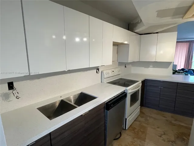 a kitchen that has a sink and a stove in it