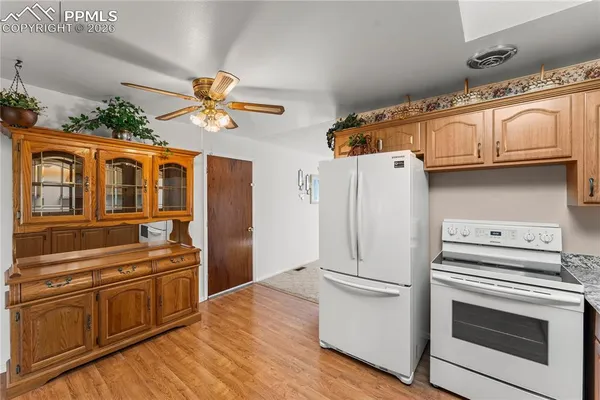 a kitchen with stainless steel appliances a stove a refrigerator and a cabinets