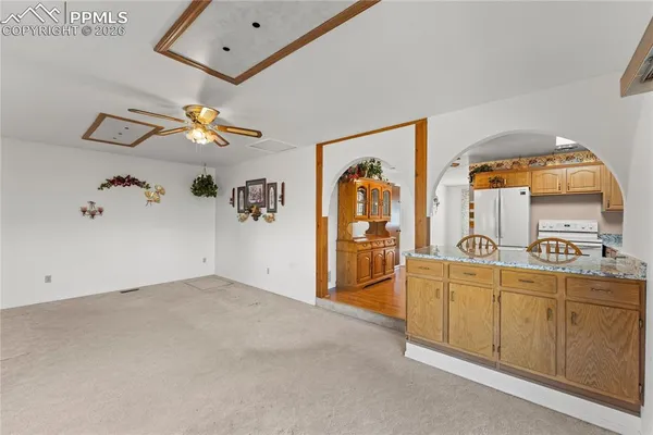 a view of a bedroom with a bed and ceiling fan