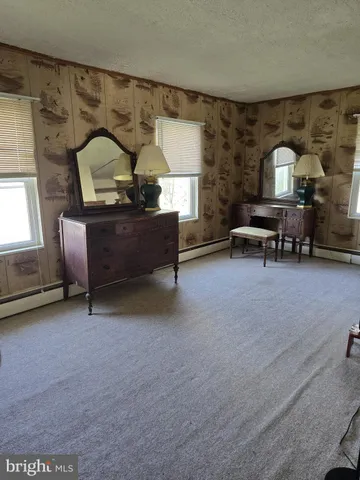 a living room with furniture and a lamp