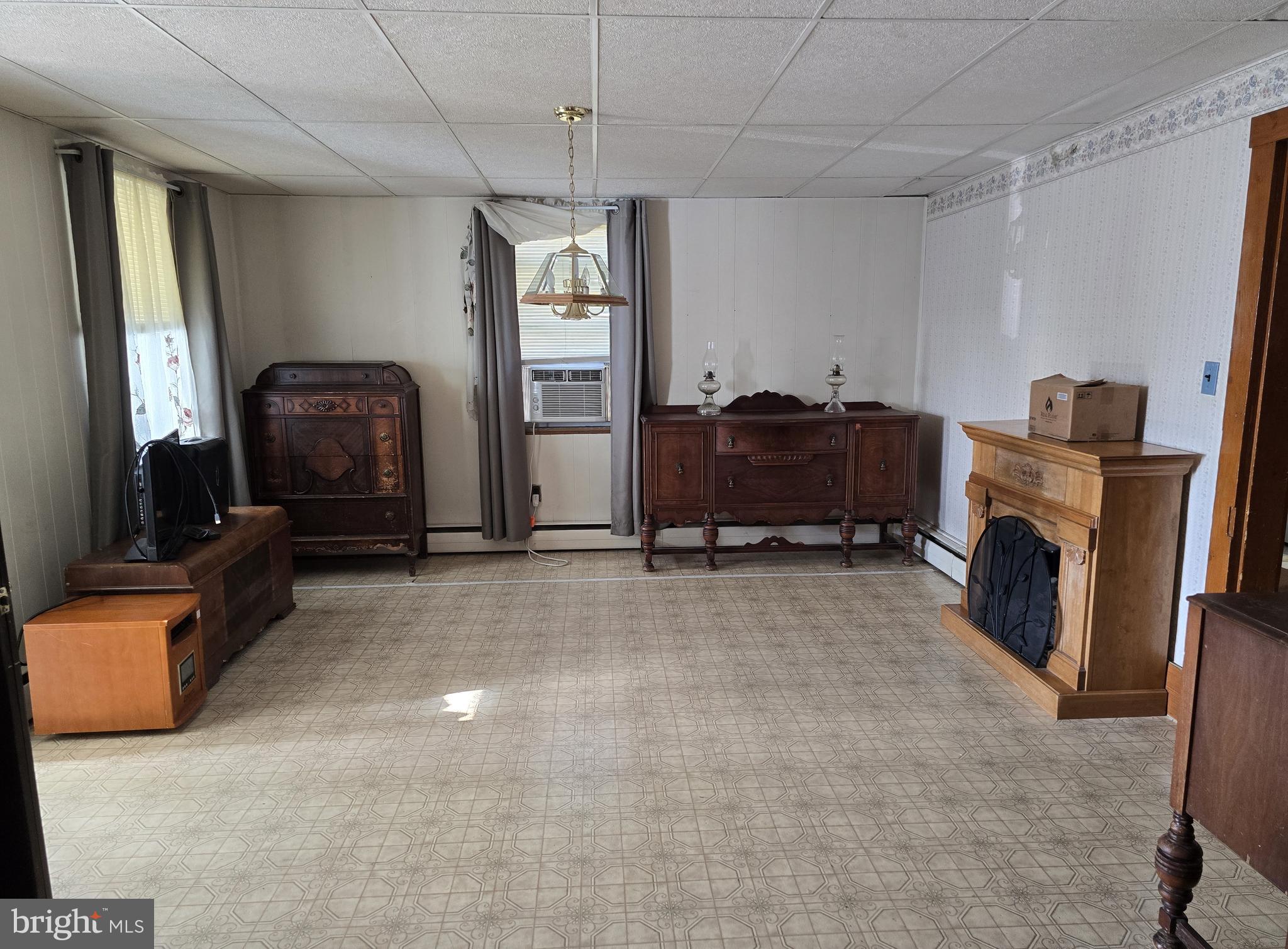 115 South Lightner Street Union Bridge, MD 21791 - Photo 2 of 19 a living room with furniture a flat screen tv and a fireplace