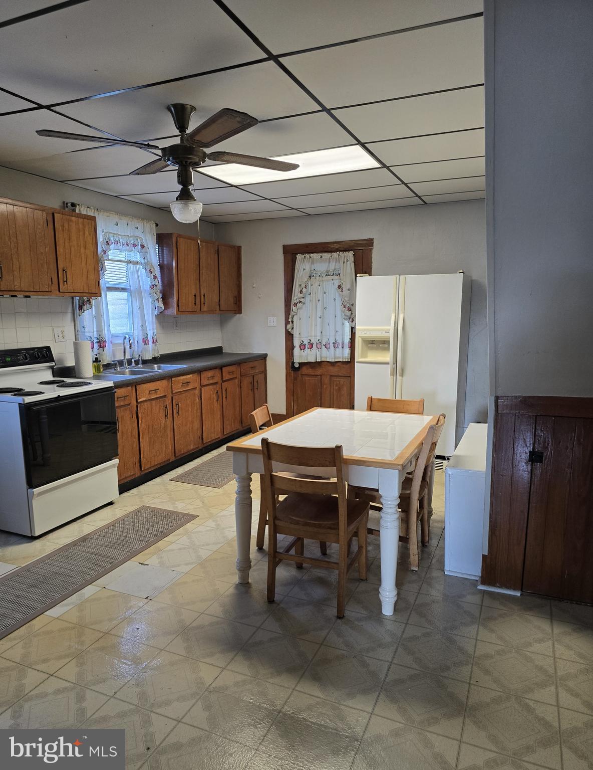115 South Lightner Street Union Bridge, MD 21791 - Photo 4 of 19 a kitchen with a table chairs microwave and cabinets