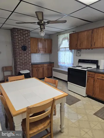 a kitchen with a table chairs and a stove