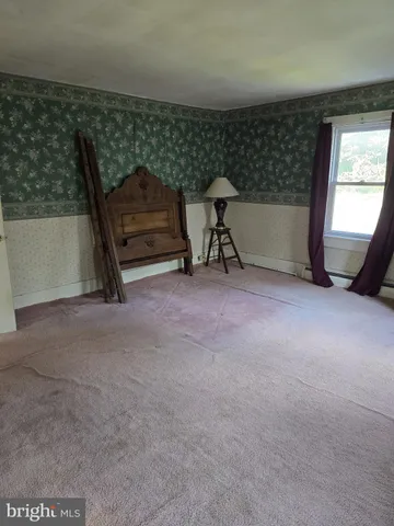 a view of an empty room with a fireplace