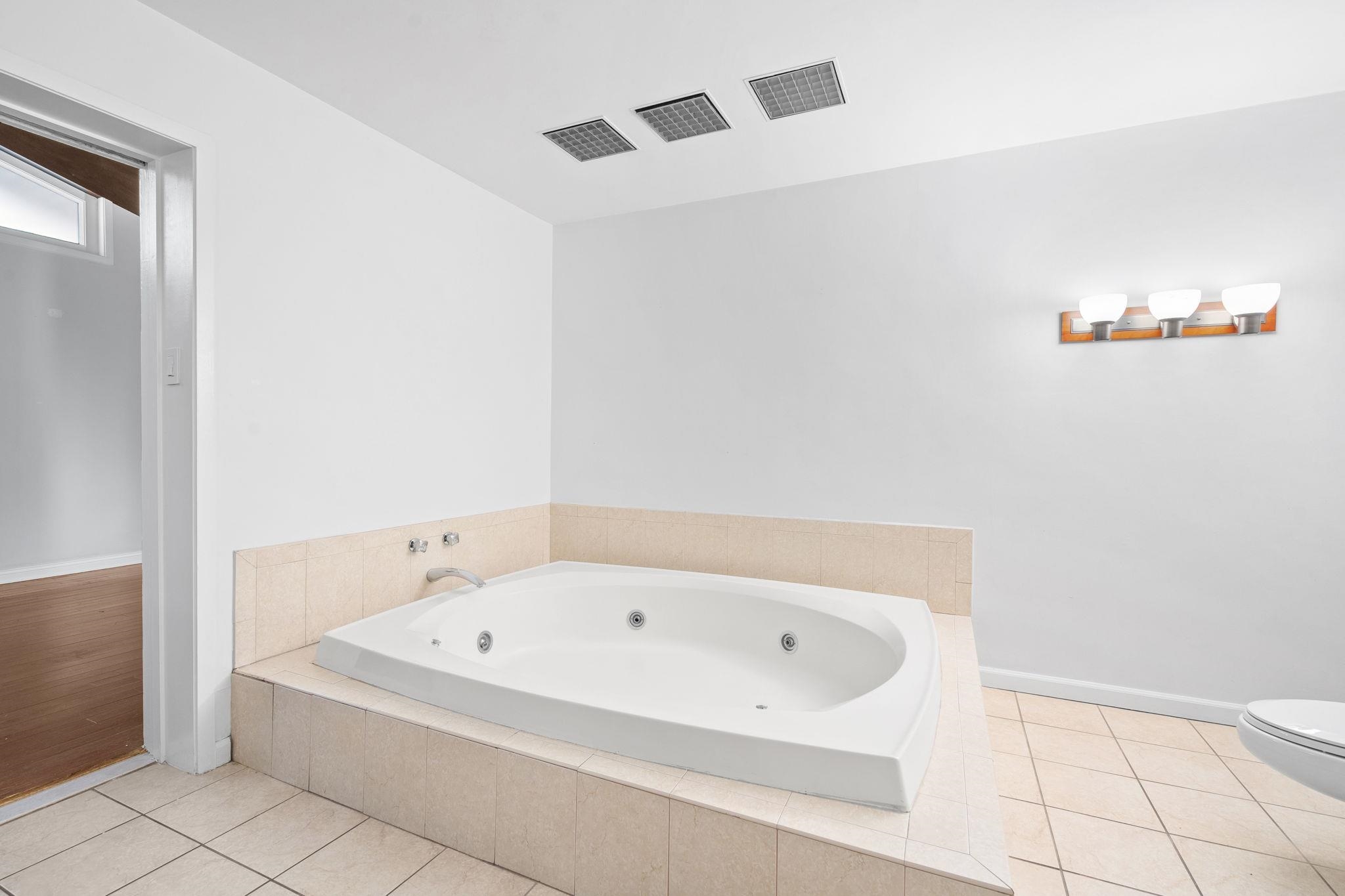 76 Hackensack Plank Road Weehawken, NJ 07086 - Photo 16 of 44 a bathroom with a bathtub and a shower