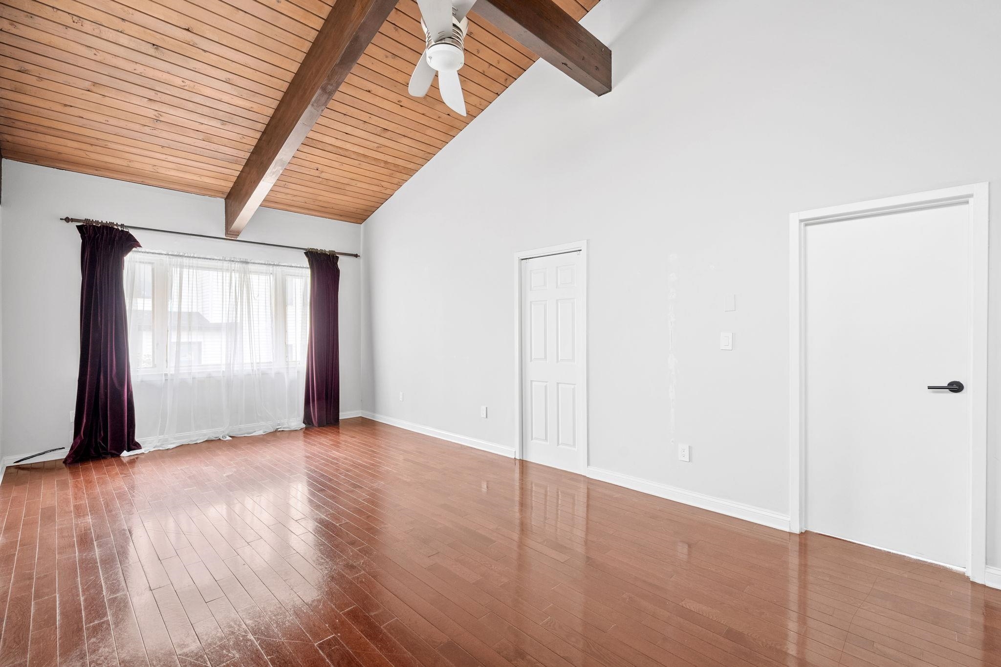 76 Hackensack Plank Road Weehawken, NJ 07086 - Photo 19 of 44 an empty room with wooden floor and windows
