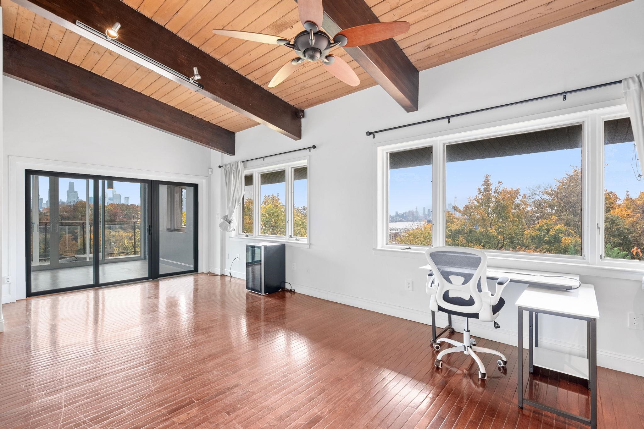 76 Hackensack Plank Road Weehawken, NJ 07086 - Photo 20 of 44 a view of a livingroom with furniture window and wooden floor