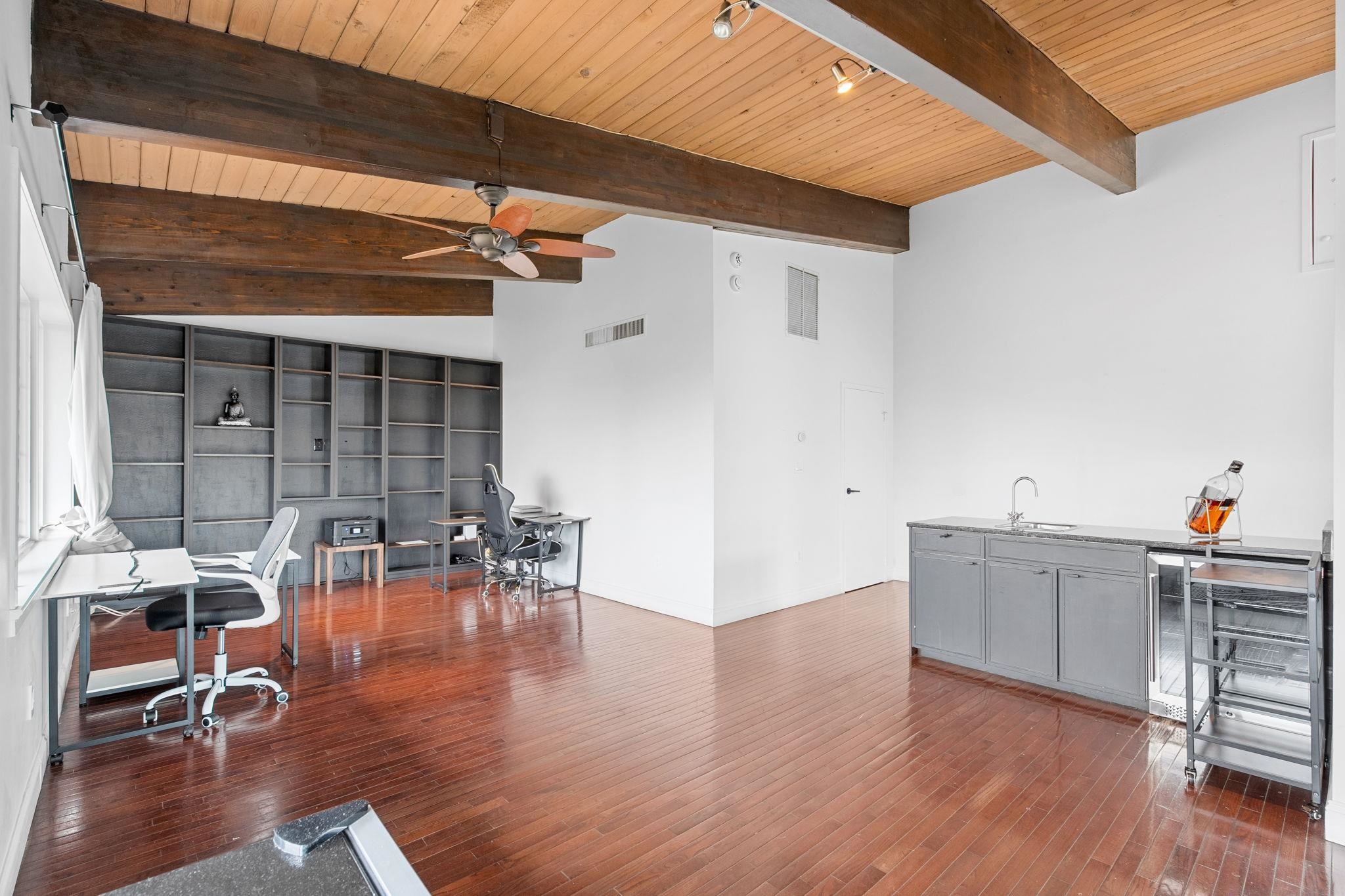 76 Hackensack Plank Road Weehawken, NJ 07086 - Photo 22 of 44 a dining room with wooden floor a chandelier a glass table and chairs