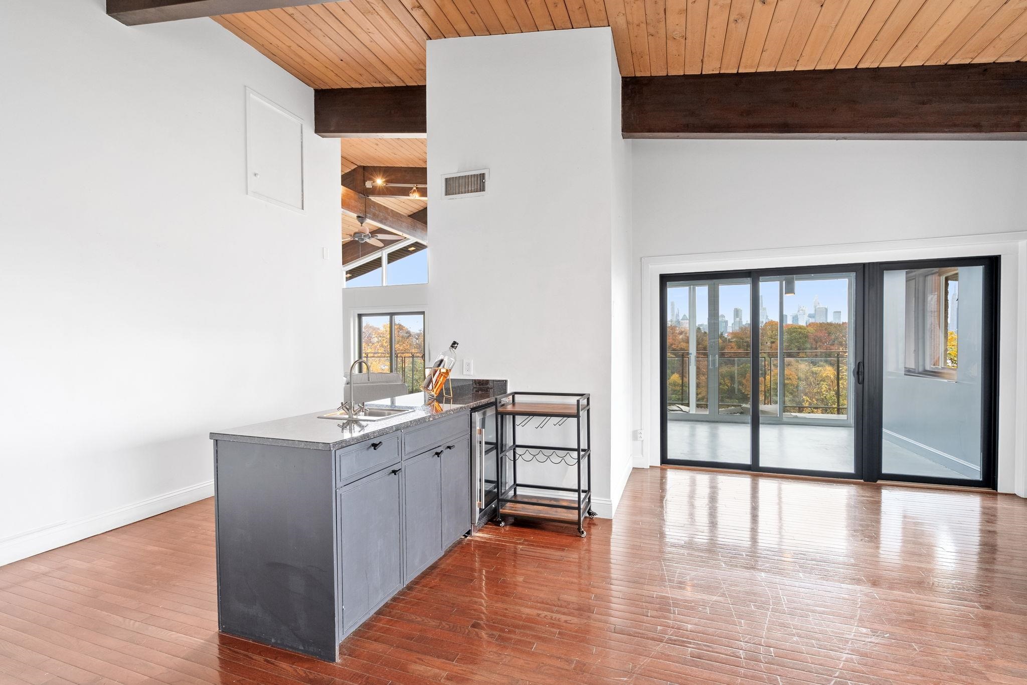 76 Hackensack Plank Road Weehawken, NJ 07086 - Photo 24 of 44 a view of a kitchen with a sink cabinets and a floor to ceiling window