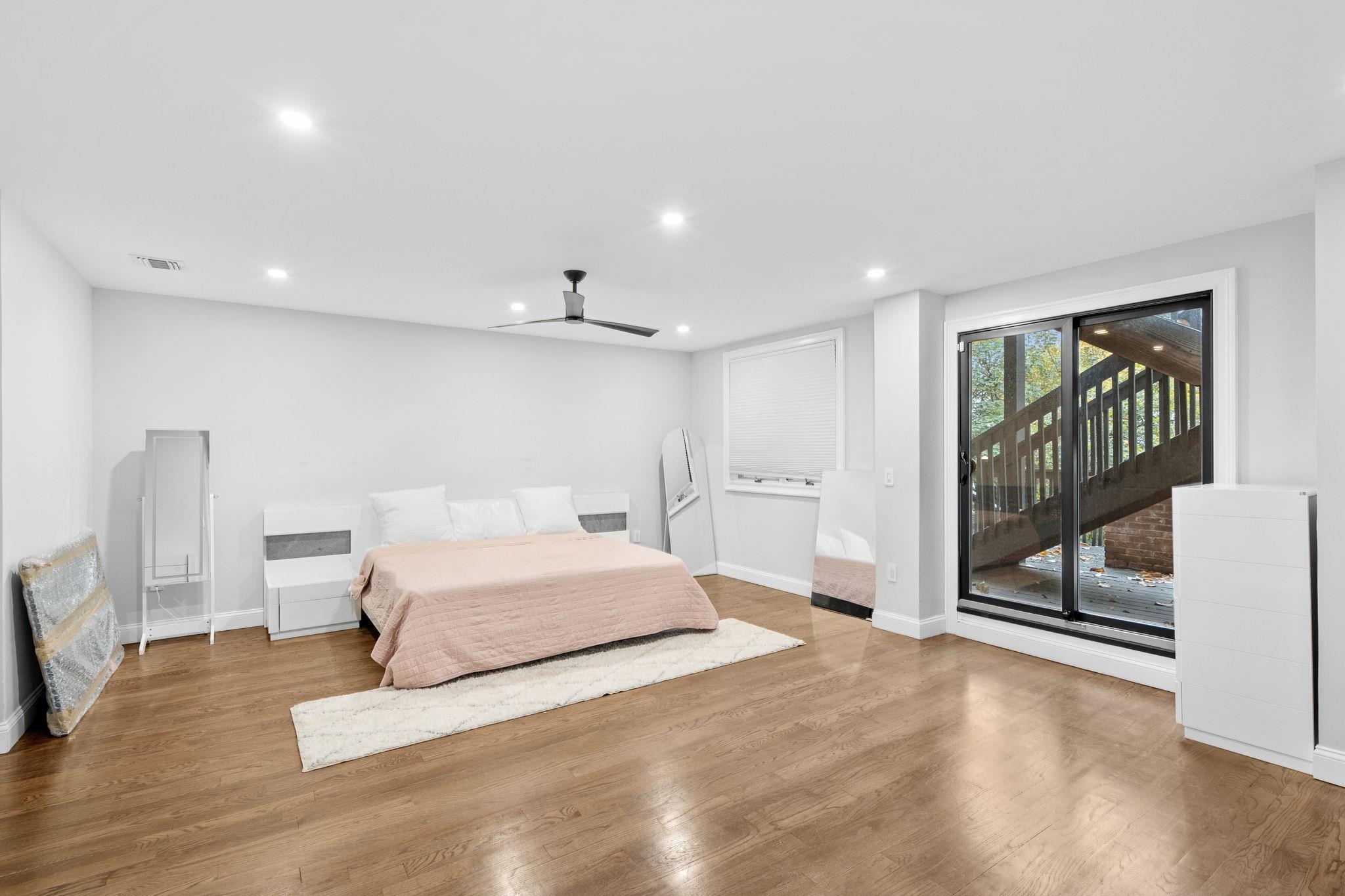 76 Hackensack Plank Road Weehawken, NJ 07086 - Photo 37 of 44 a spacious bedroom with a large bed and a chandelier