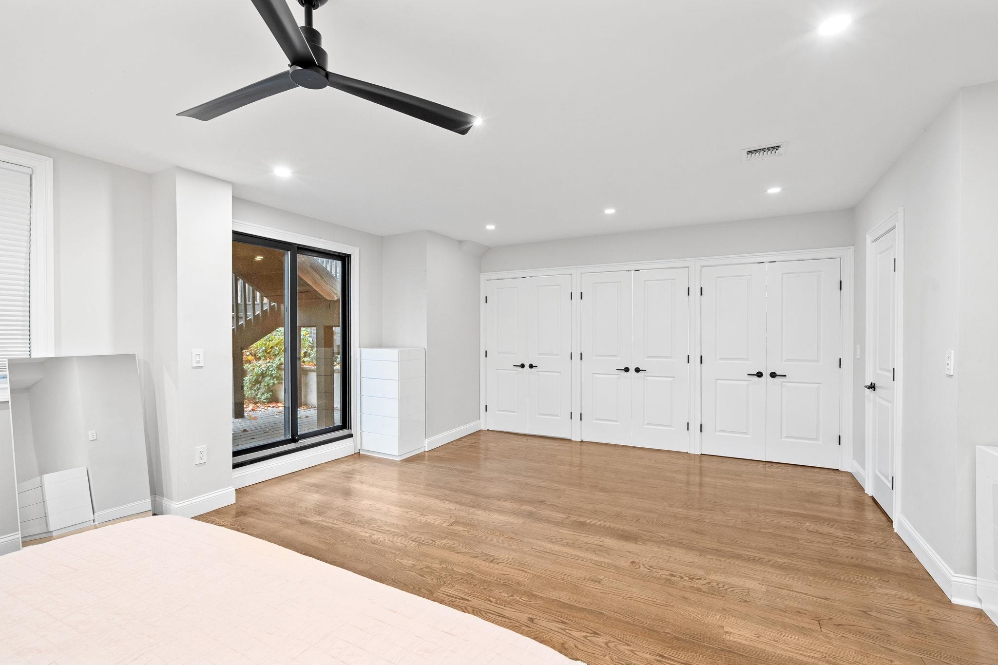 76 Hackensack Plank Road Weehawken, NJ 07086 - Photo 38 of 44 a view of an empty room with a window and wooden floor