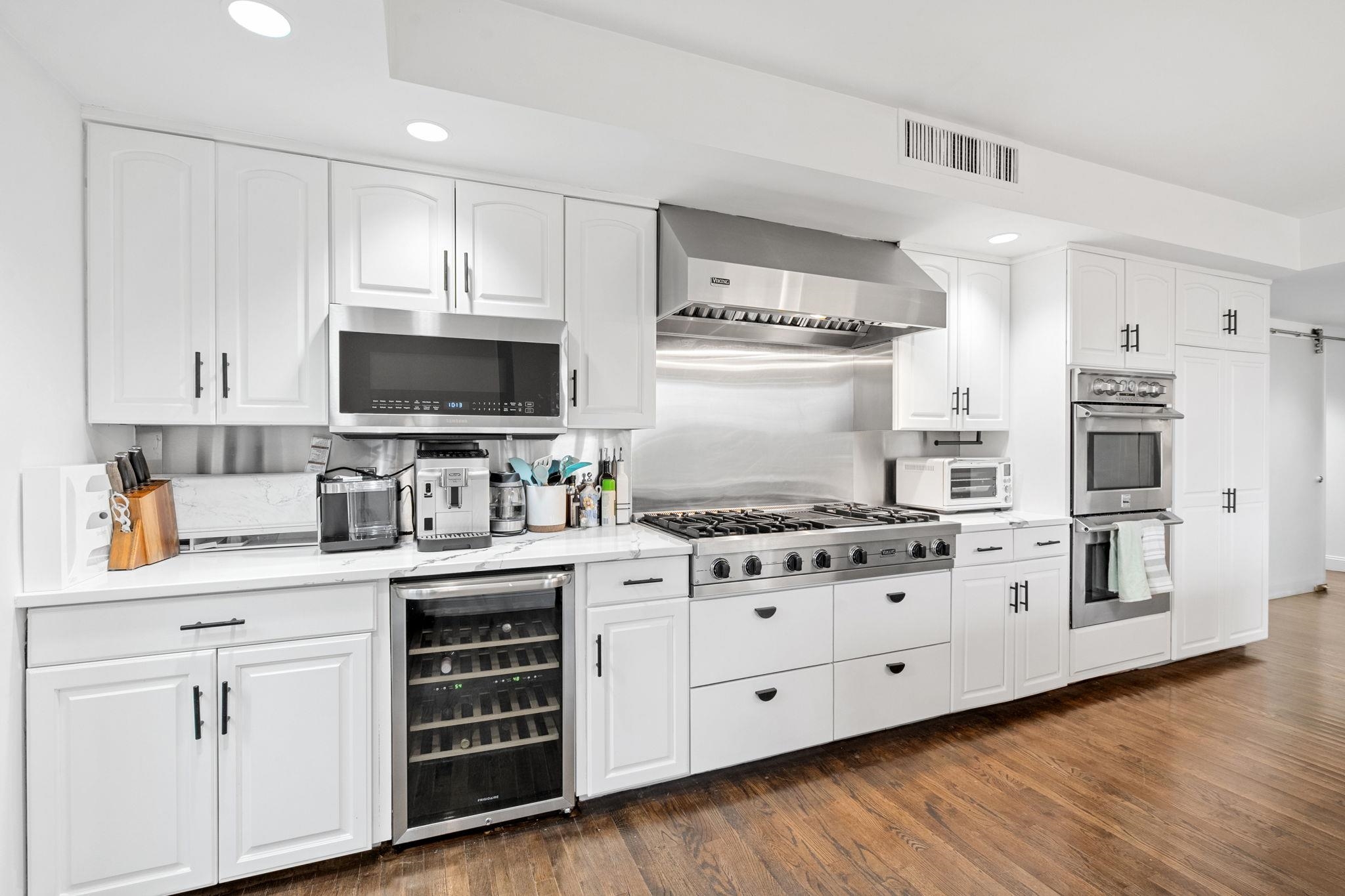 76 Hackensack Plank Road Weehawken, NJ 07086 - Photo 5 of 44 a kitchen with stainless steel appliances granite countertop a stove a sink and a refrigerator