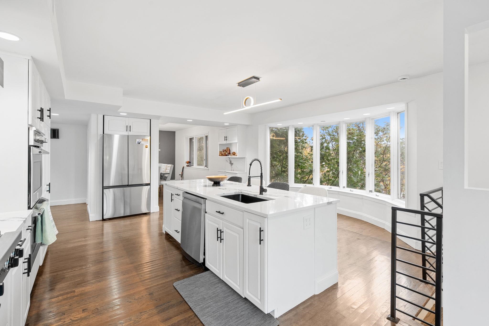 76 Hackensack Plank Road Weehawken, NJ 07086 - Photo 6 of 44 a kitchen with stainless steel appliances granite countertop a stove and a refrigerator
