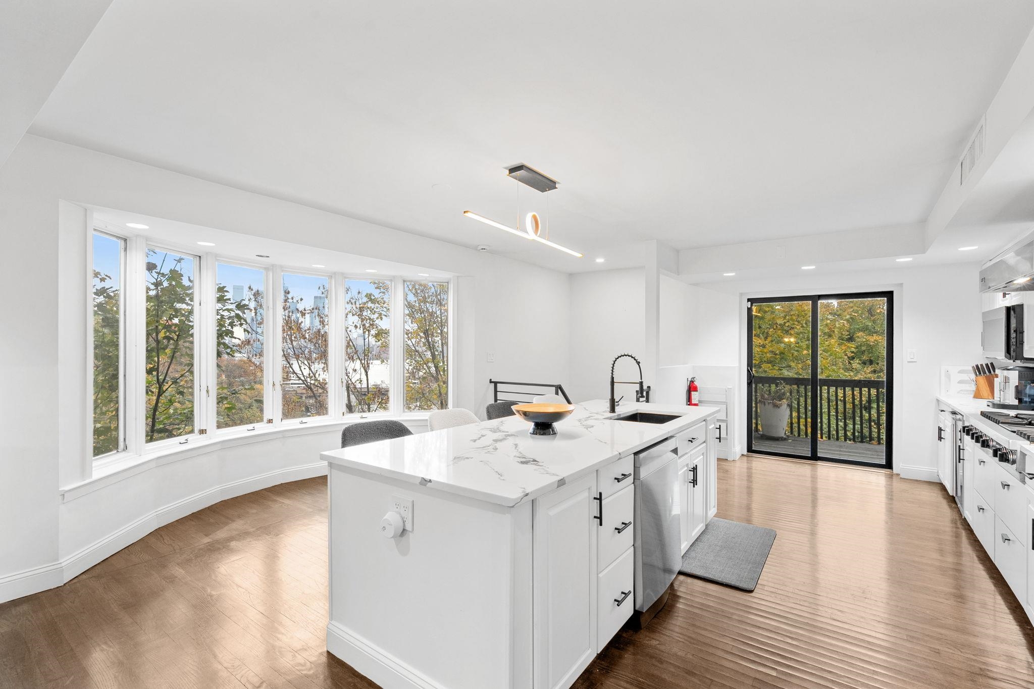 76 Hackensack Plank Road Weehawken, NJ 07086 - Photo 7 of 44 a view of center island wooden floor and a window