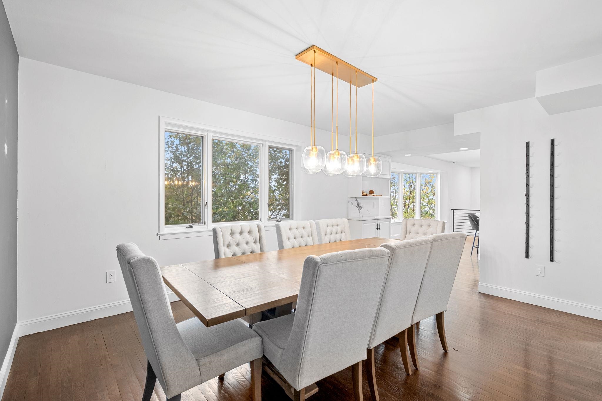 76 Hackensack Plank Road Weehawken, NJ 07086 - Photo 9 of 44 a dining room with furniture a chandelier and wooden floor