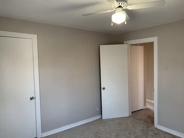 a view of a livingroom with a chandelier fan