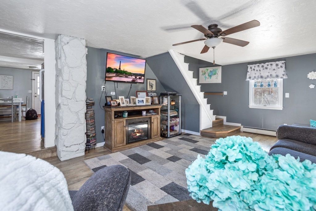 53 Rabbit Road Salisbury, MA 01952 - Photo 11 of 41 a living room with furniture and a fireplace