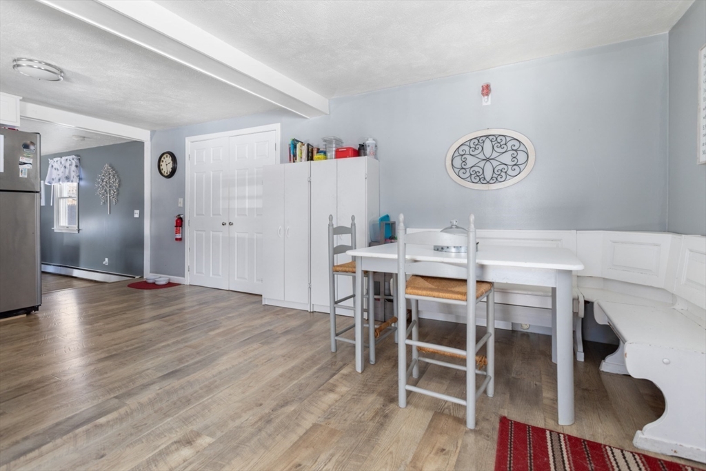 53 Rabbit Road Salisbury, MA 01952 - Photo 14 of 41 a view of a dining area with furniture and wooden floor
