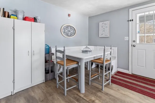 a view of a dining room with furniture and a kitchen