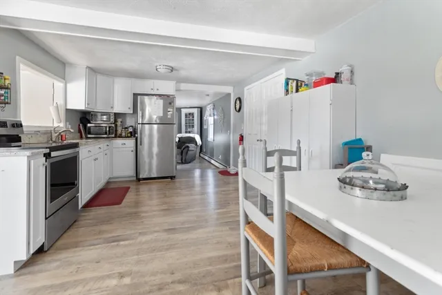 a kitchen with refrigerator and cabinets