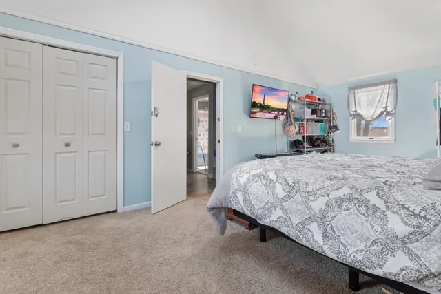 a bedroom with a bed and a dresser