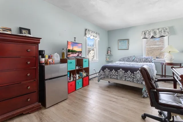a bedroom with furniture and a wooden floor
