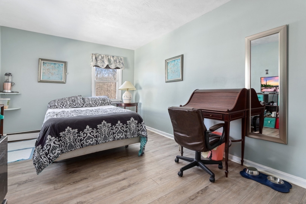 53 Rabbit Road Salisbury, MA 01952 - Photo 24 of 42 a bedroom with a bed a table and chair
