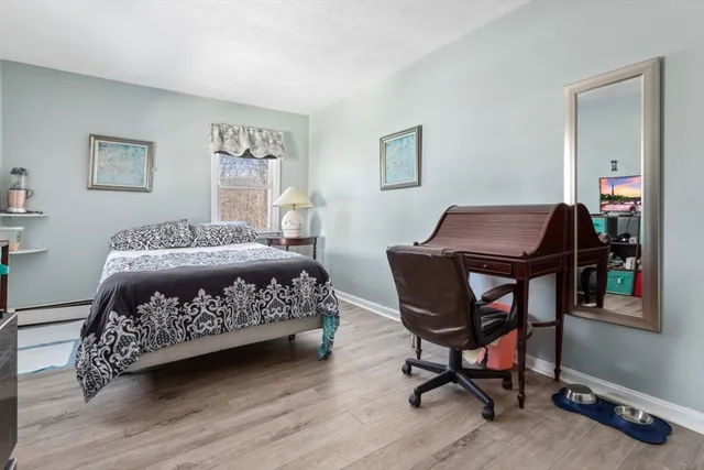 a bedroom with a bed a table and chair