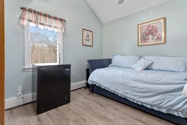 a bedroom with a bed and a window