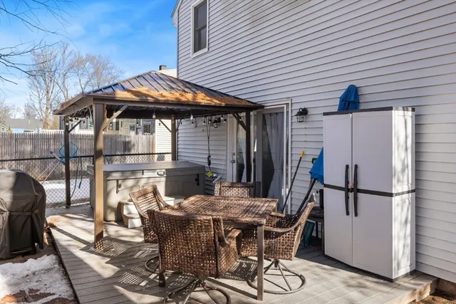 a patio with table and chairs and potted plants