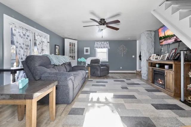 a living room with furniture a fireplace and a flat screen tv