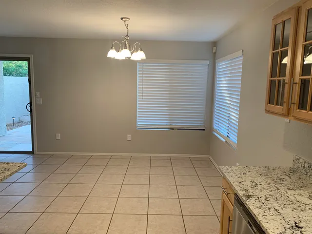 a view of a kitchen cabinets and chandelier