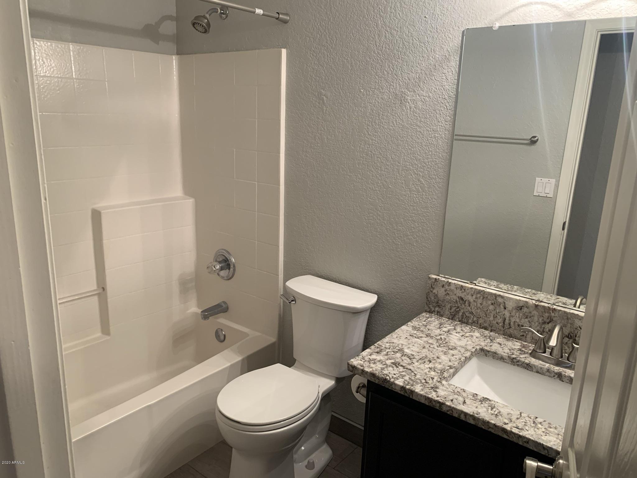 21842 North 40th Place Phoenix, AZ 85050 - Photo 18 of 42 a bathroom with a granite countertop sink toilet and shower