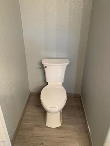 a white toilet sitting in a bathroom