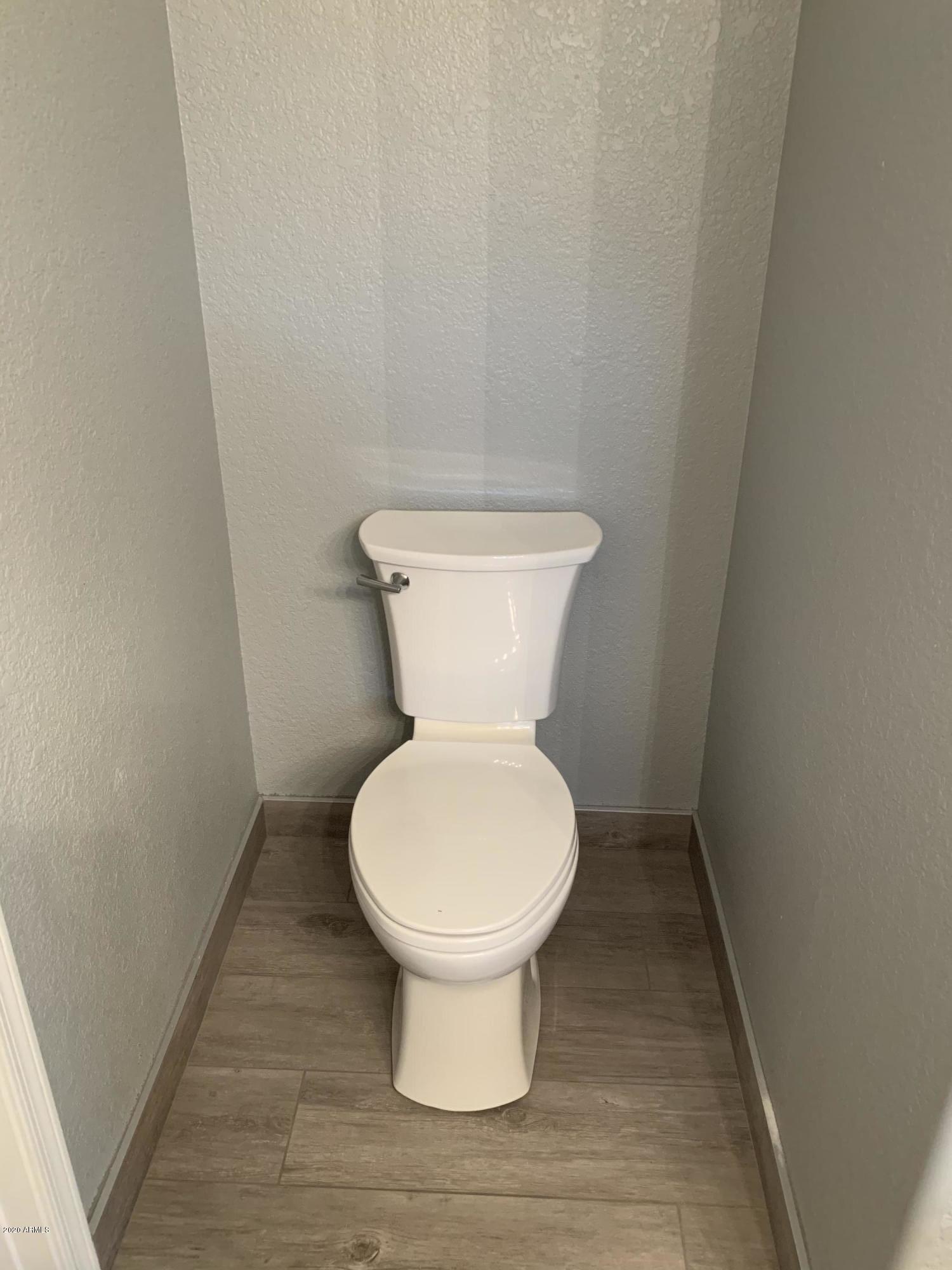 21842 North 40th Place Phoenix, AZ 85050 - Photo 26 of 42 a white toilet sitting in a bathroom