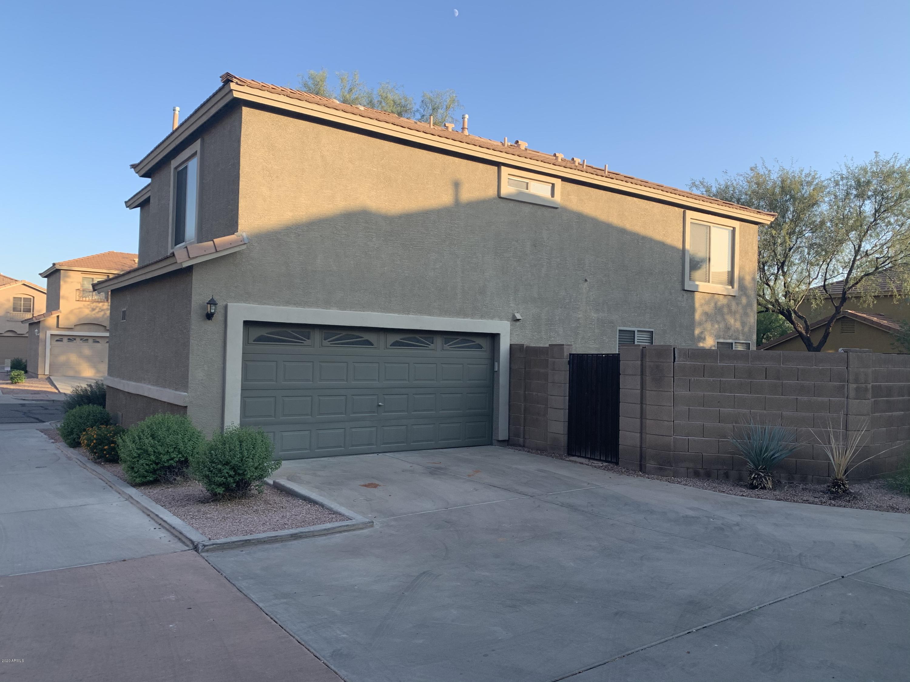 21842 North 40th Place Phoenix, AZ 85050 - Photo 3 of 42 a front view of a house with garage