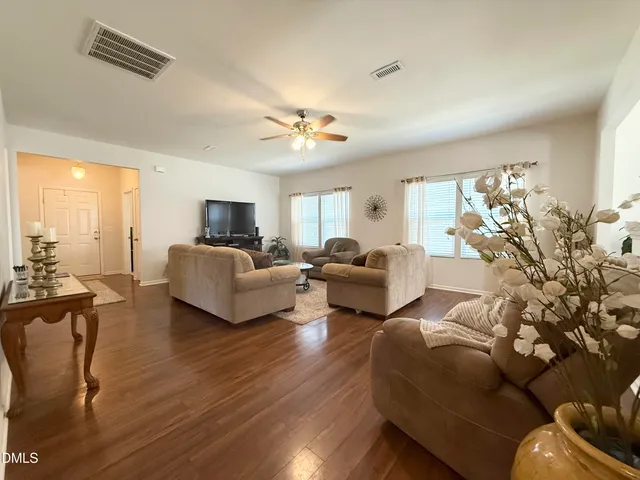 a living room with furniture fireplace and a flat screen tv