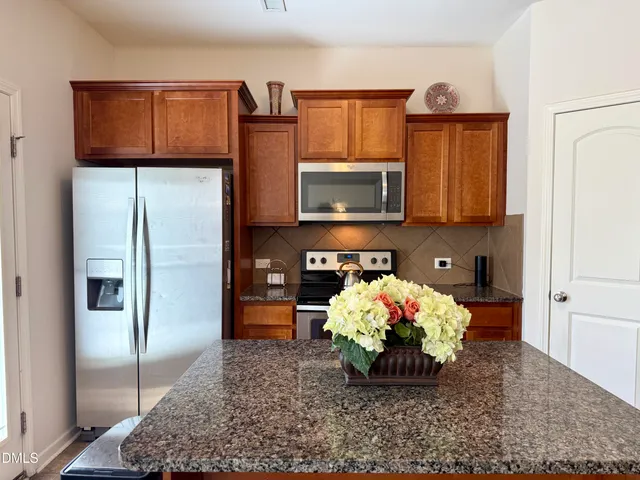 a kitchen with a refrigerator and a microwave