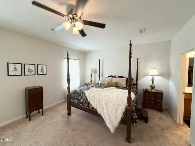 a bedroom with a bed a desk and chair