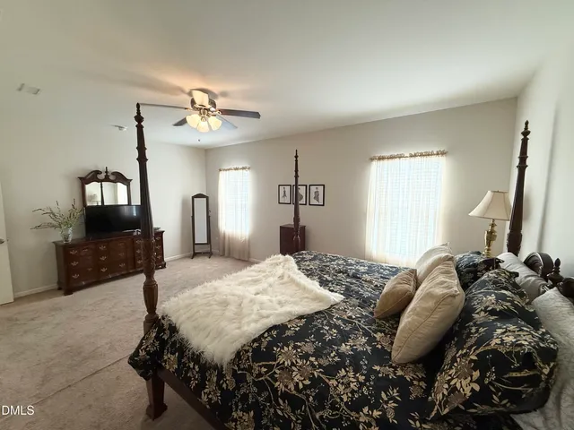a bed sitting in a bedroom and chair