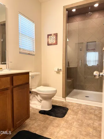 a bathroom with a toilet sink and shower